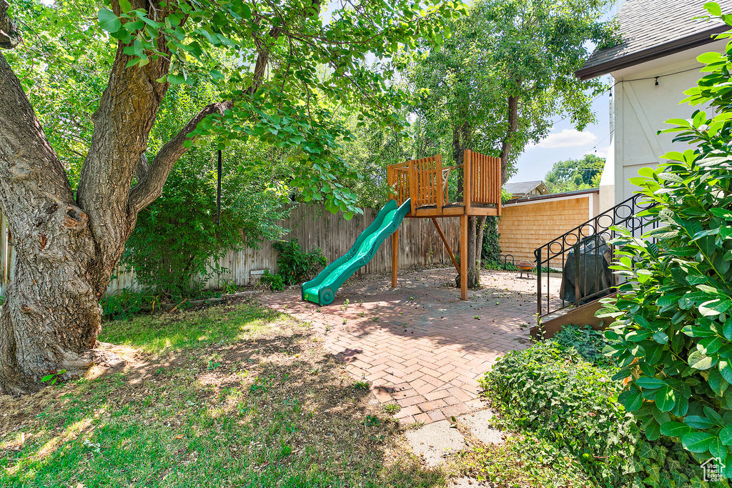 View of jungle gym with a patio