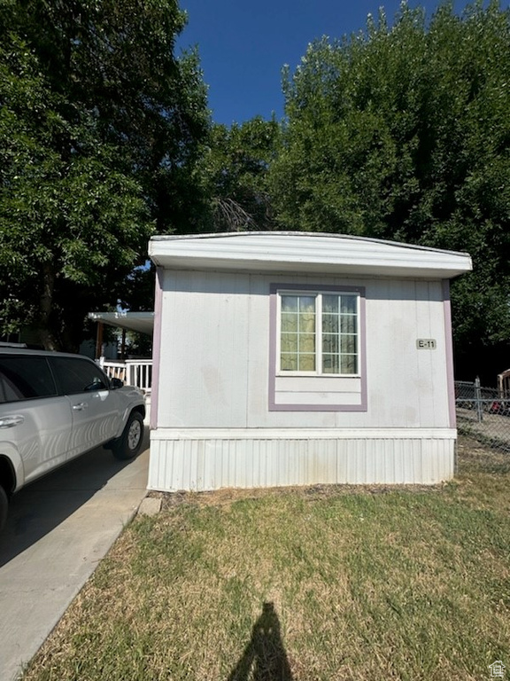 View of side of home with a yard