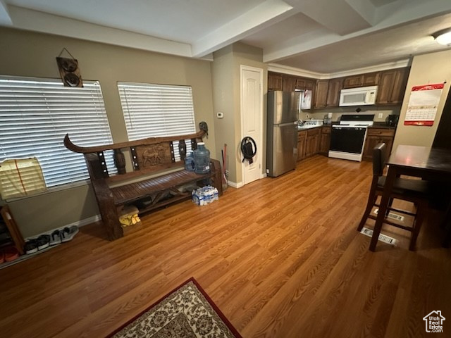 Living room with beam ceiling and hardwood / wood-style flooring