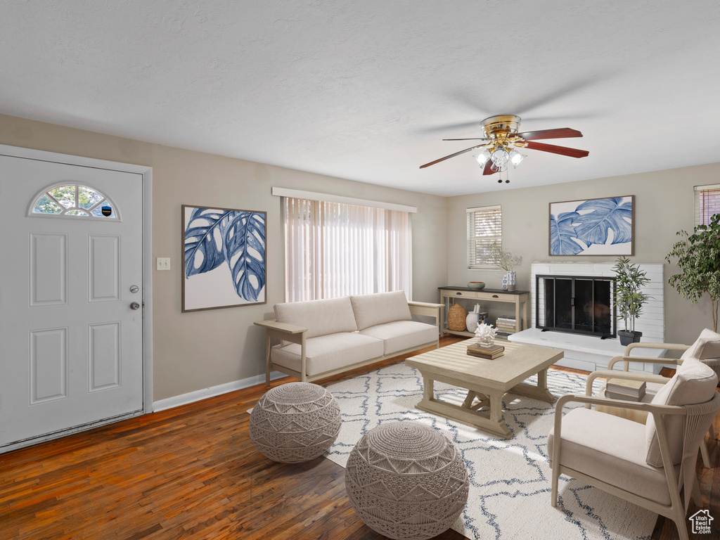 Living room featuring wood-type flooring and ceiling fan