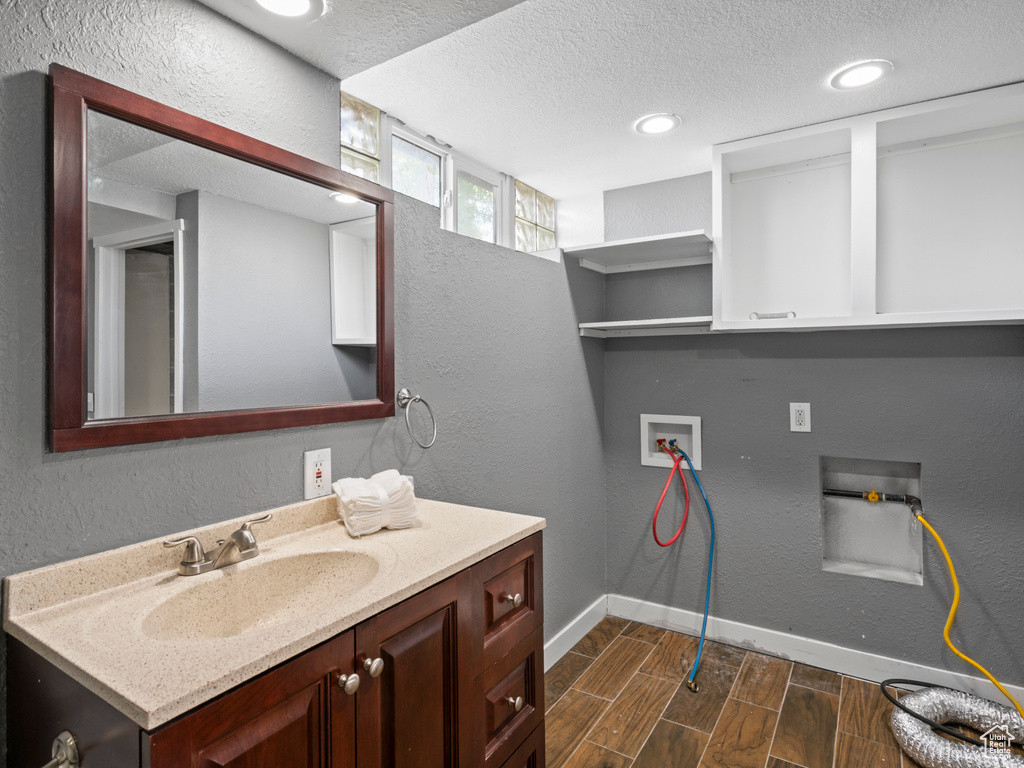 Bathroom with vanity and a textured ceiling