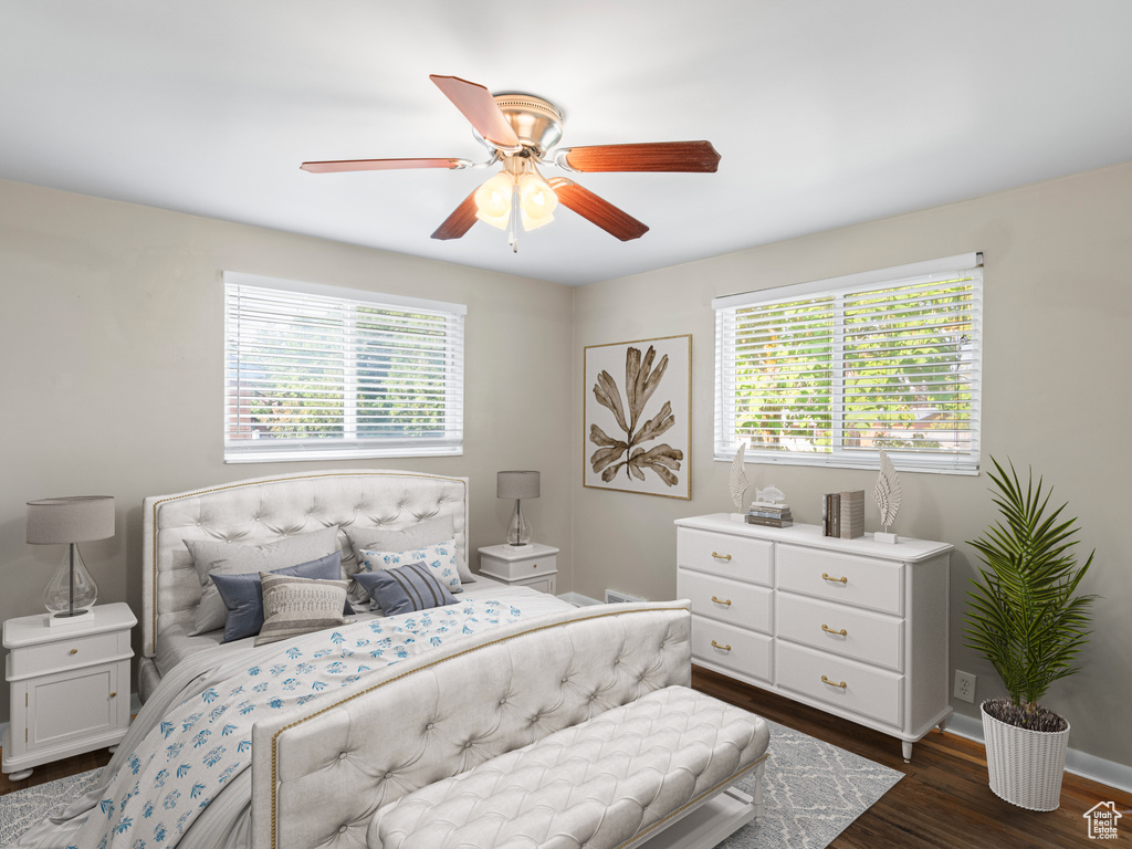 Bedroom with dark hardwood / wood-style flooring and ceiling fan