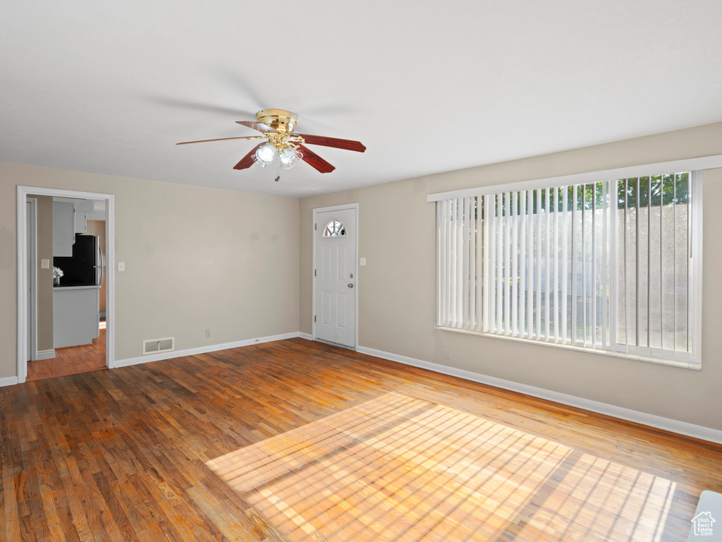 Empty room featuring light hardwood / wood-style floors and ceiling fan