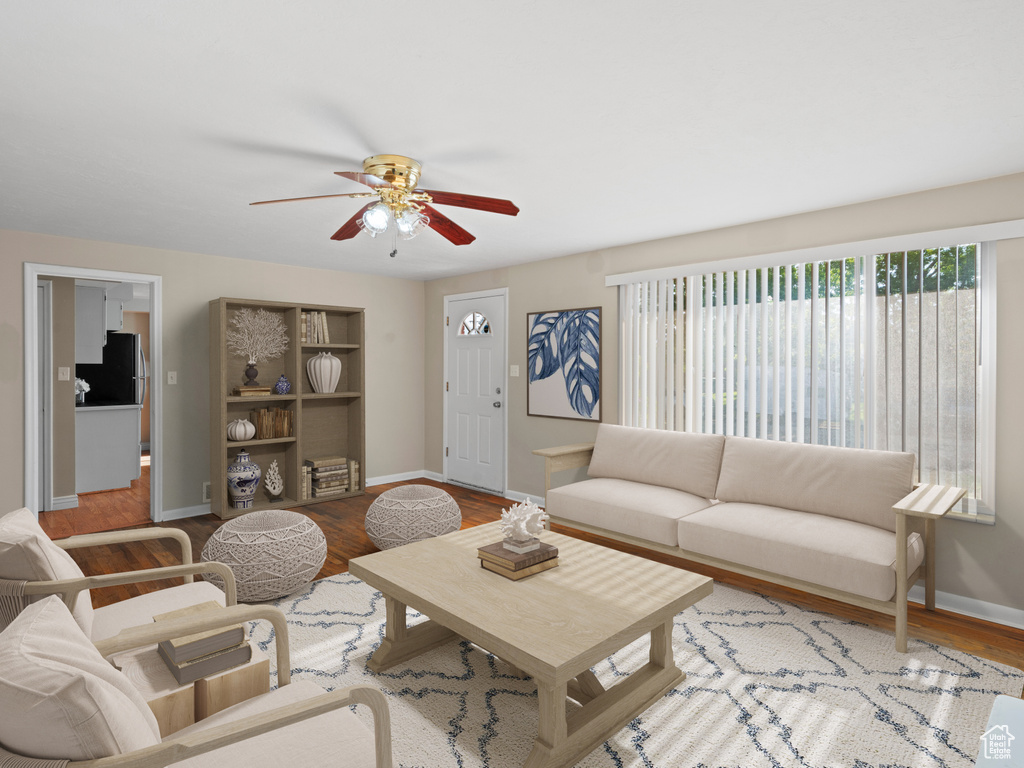 Living room featuring ceiling fan and light wood-type flooring