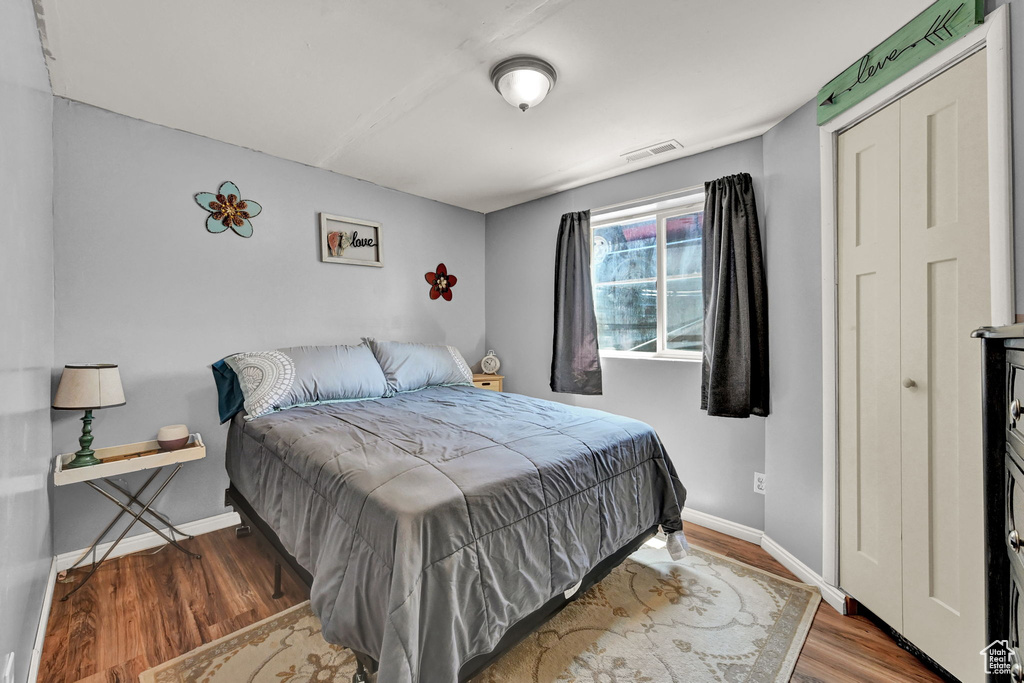 Bedroom with a closet and wood-type flooring