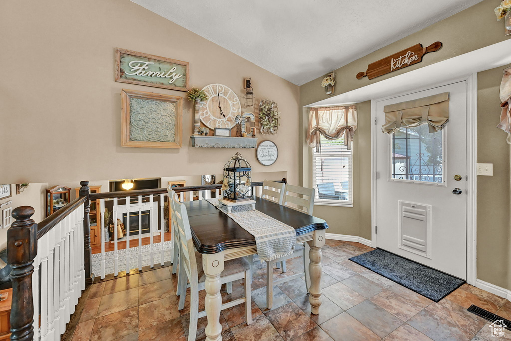 Tiled dining space with vaulted ceiling