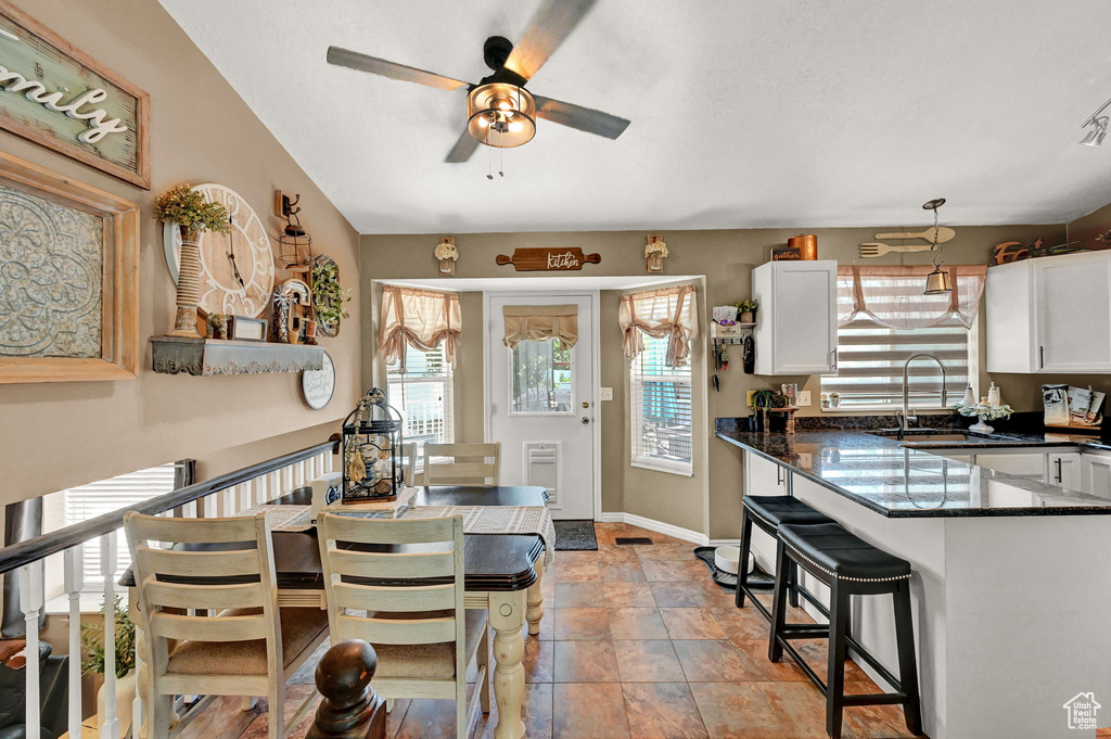 Tiled dining area featuring sink and ceiling fan