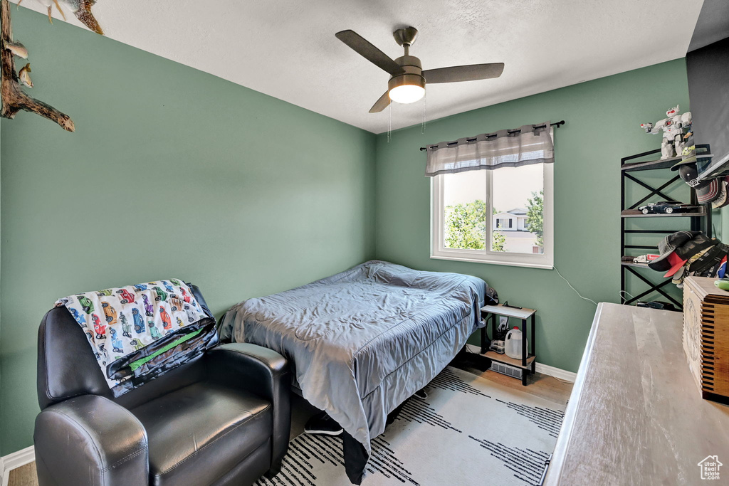 Bedroom with wood-type flooring and ceiling fan