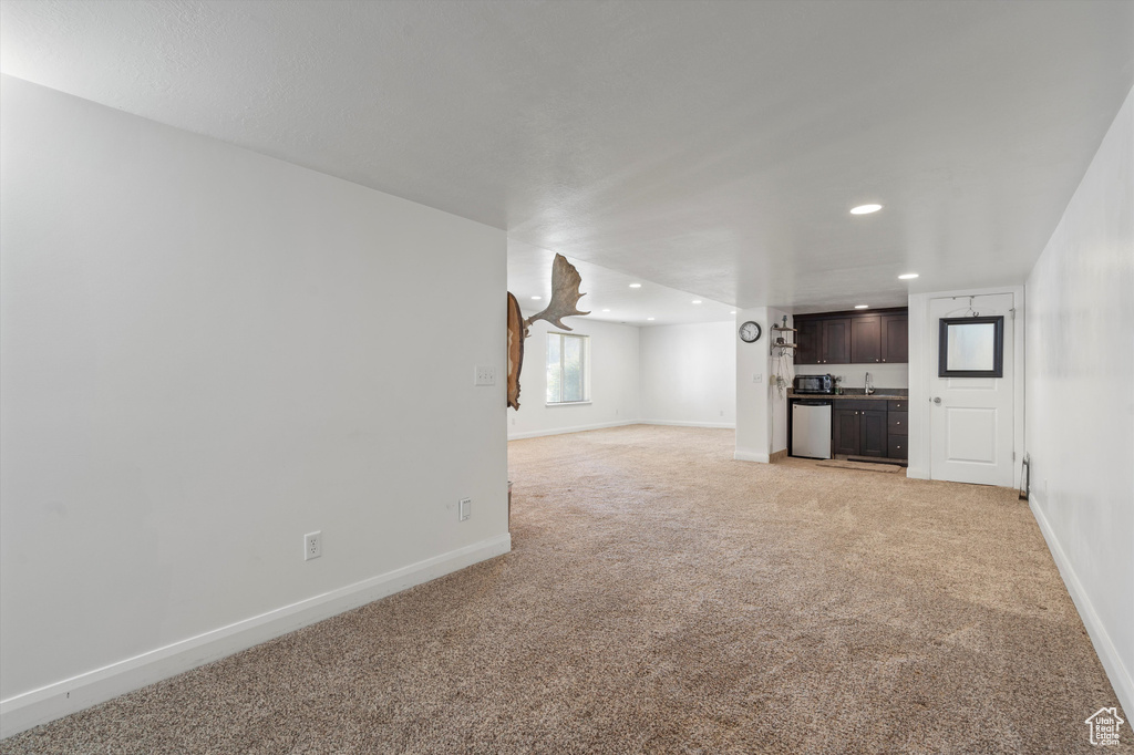 Unfurnished living room with light colored carpet