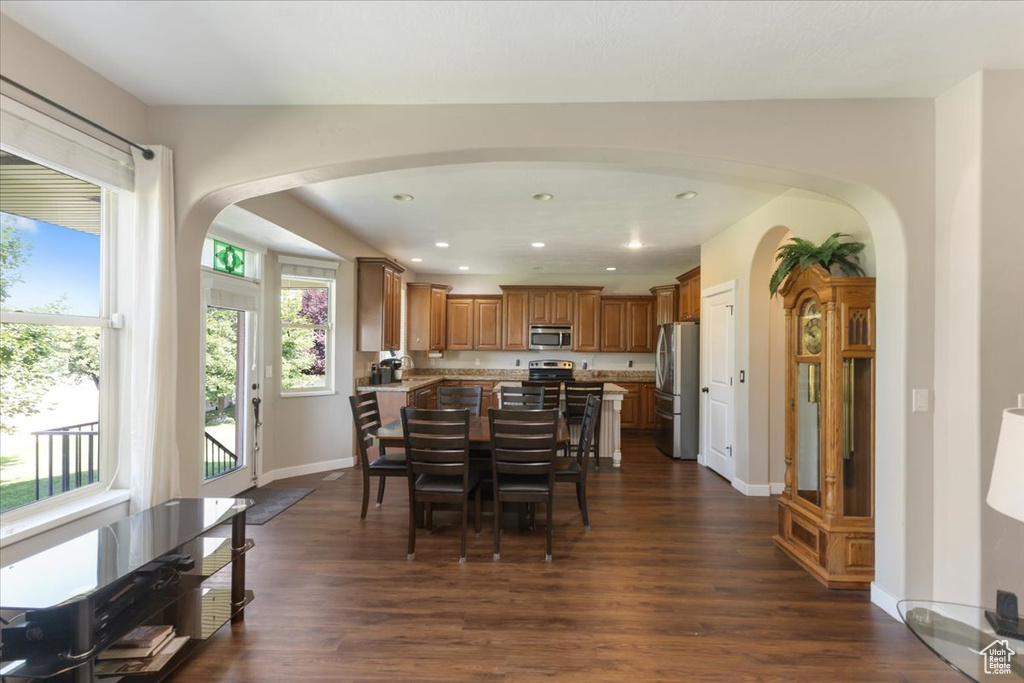 Dining area with dark hardwood / wood-style flooring