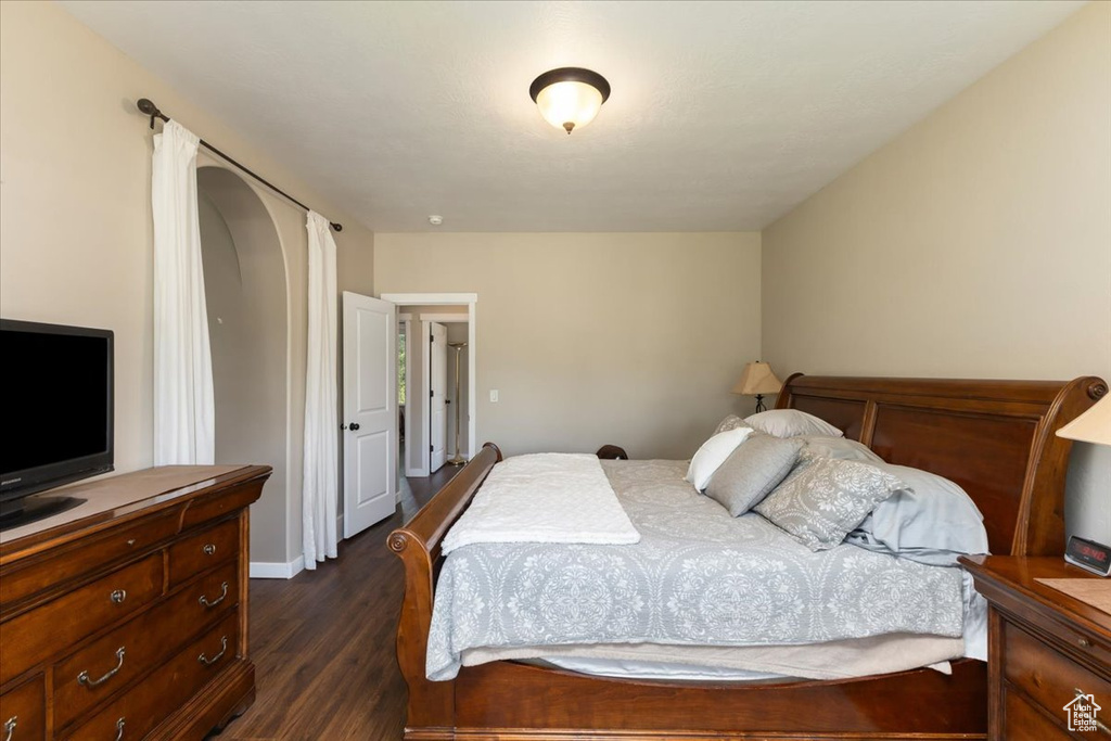 Bedroom with dark hardwood / wood-style floors