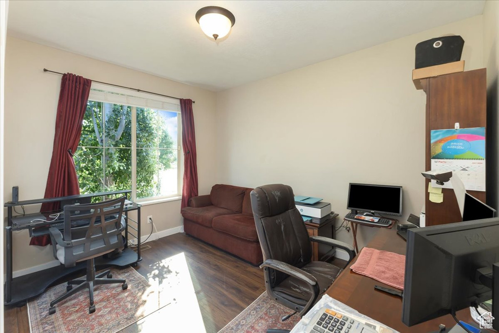 Office area with dark hardwood / wood-style floors