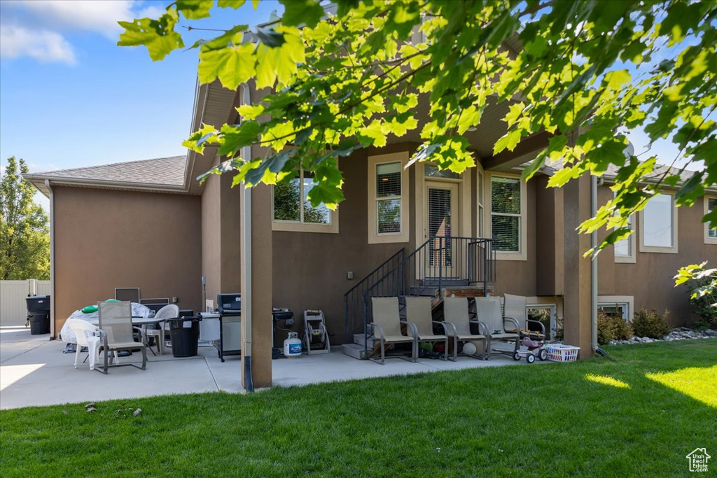 Back of house featuring a patio area and a lawn