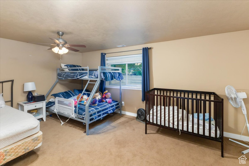 Bedroom featuring light carpet and ceiling fan