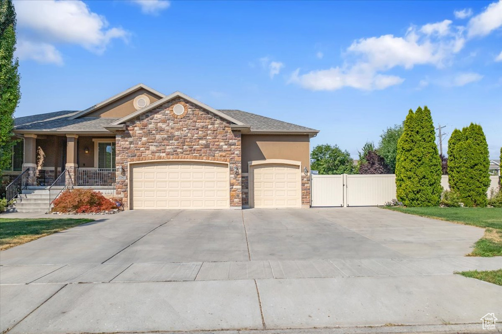 View of front of property featuring a garage and a porch