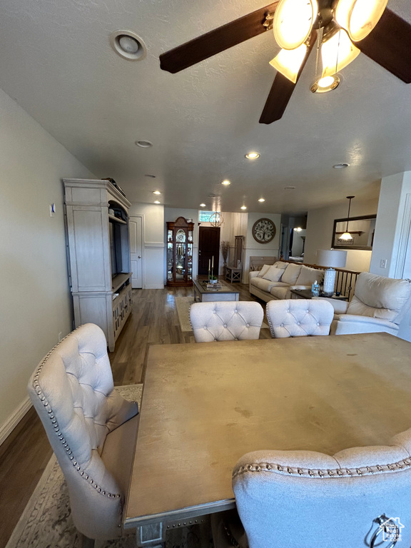 Living room with hardwood / wood-style floors and ceiling fan