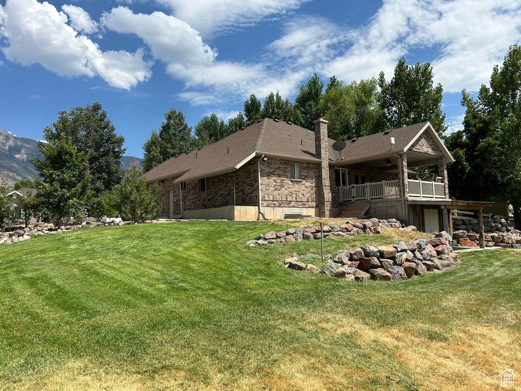 Rear view of house with a yard