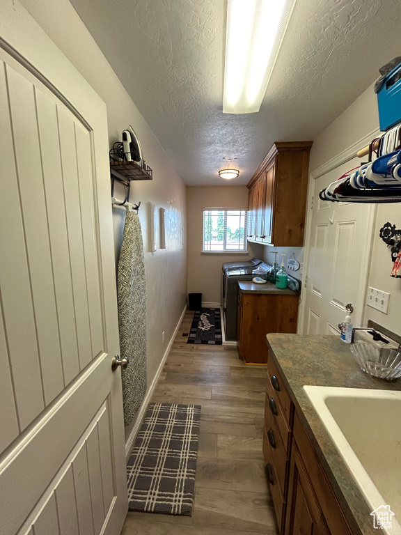 Interior space featuring sink, a textured ceiling, and hardwood / wood-style floors