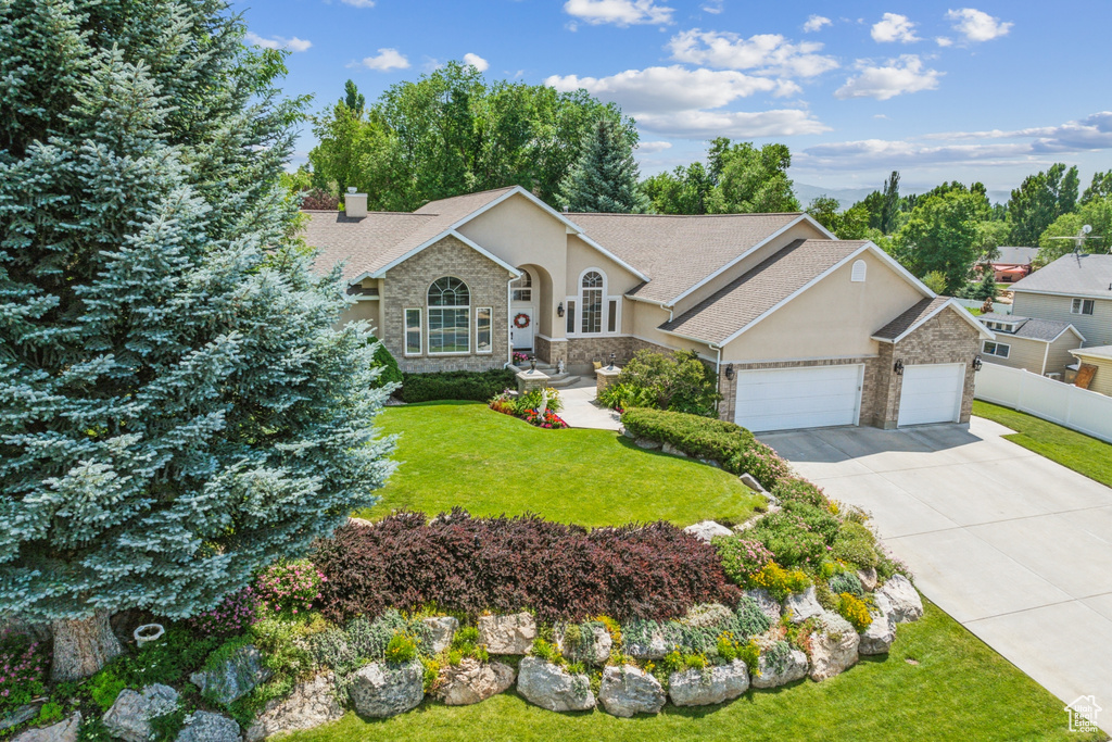 Ranch-style home with a garage and a front yard