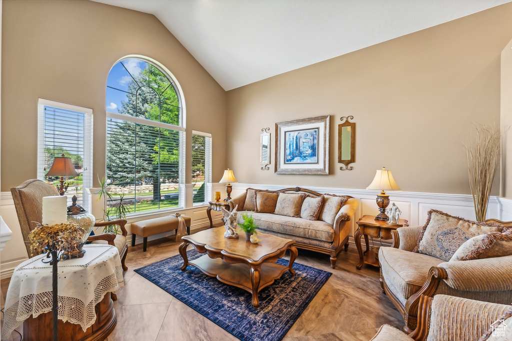 Living room with a healthy amount of sunlight and high vaulted ceiling