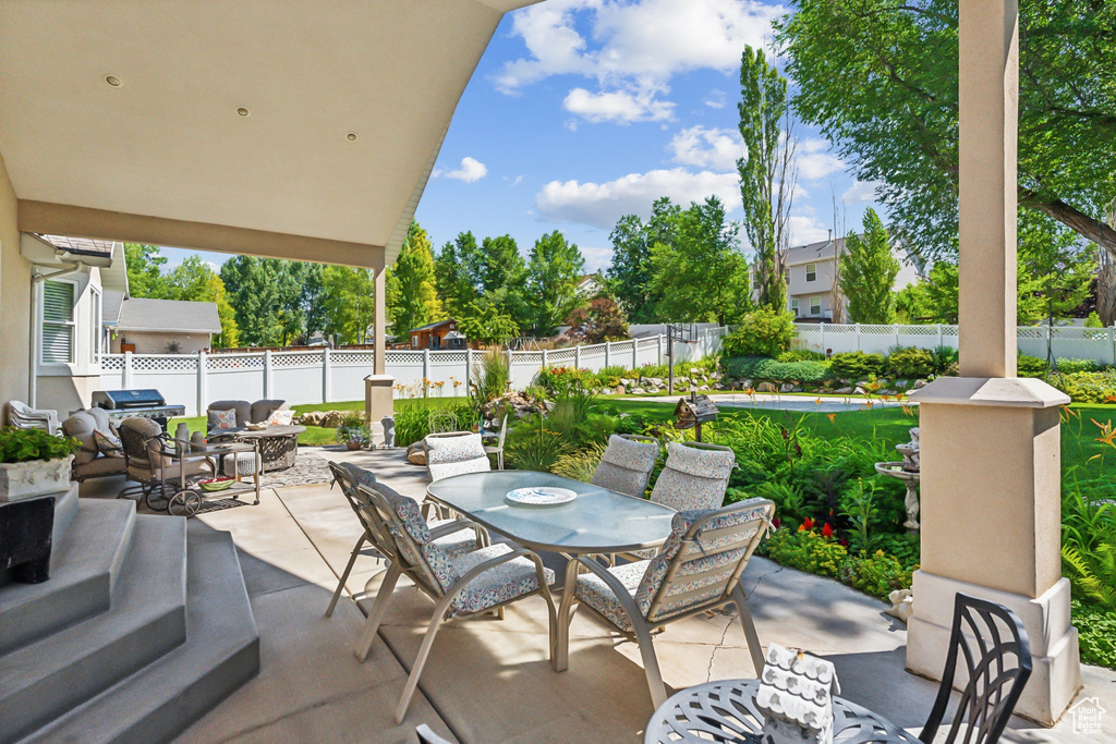 View of patio with an outdoor living space and a swimming pool