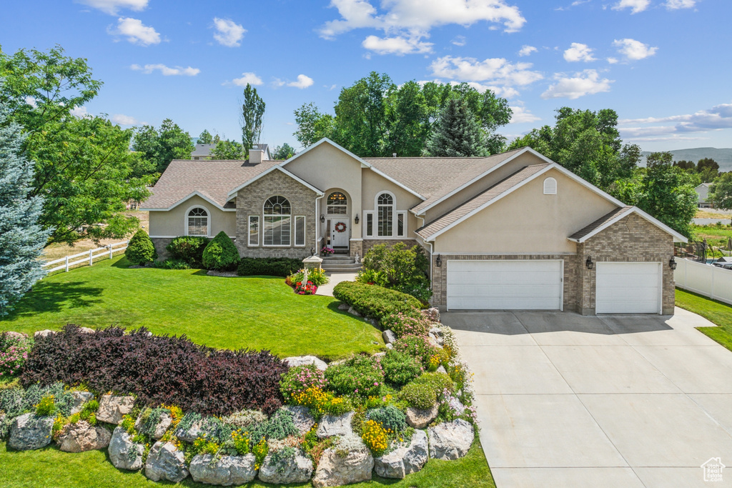 Ranch-style house with a garage and a front yard