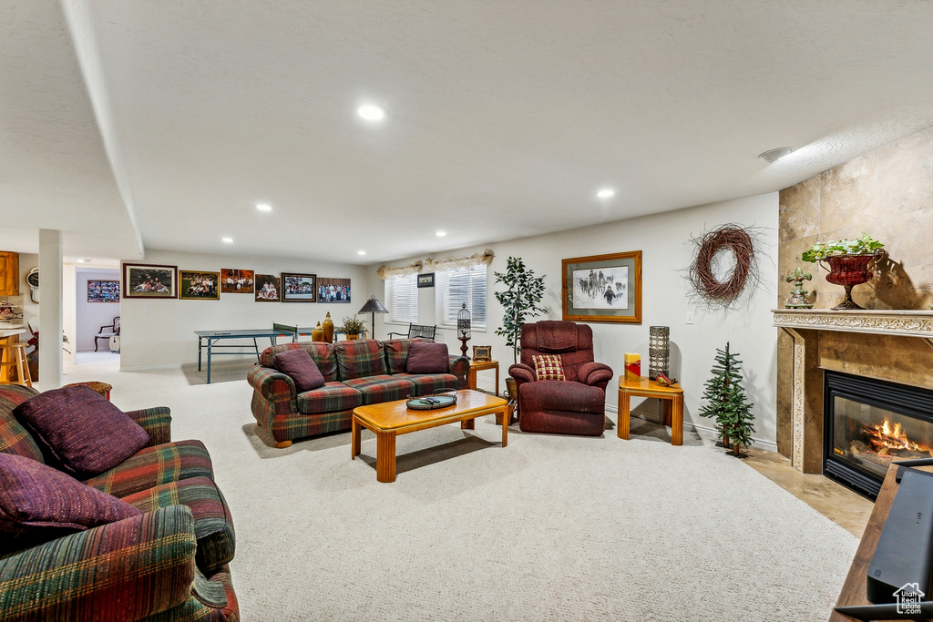 Living room featuring a large fireplace and light carpet