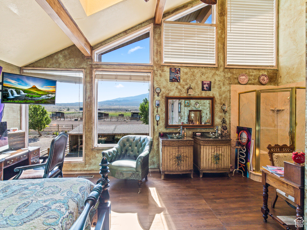 Interior space featuring high vaulted ceiling, beamed ceiling, hardwood / wood-style flooring, and a mountain view