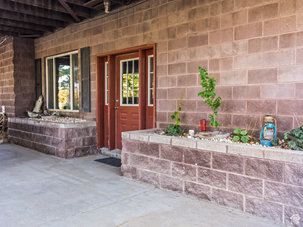 Doorway to property with a patio area