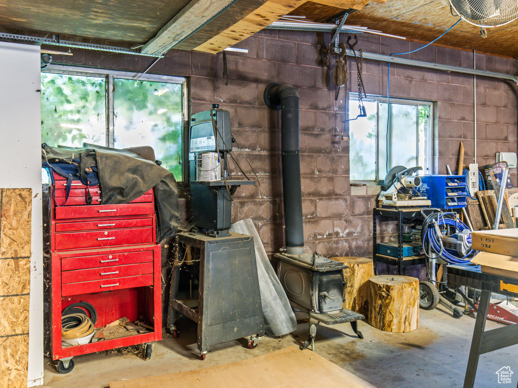 Interior space featuring concrete floors and a wood stove