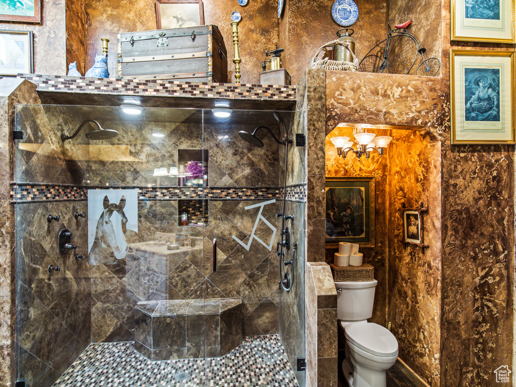 Bathroom with toilet, walk in shower, and tile walls