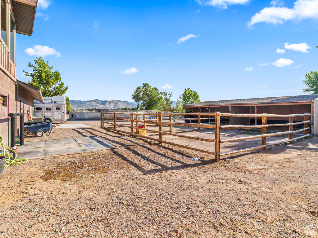 View of horse barn featuring a mountain view and an outdoor structure