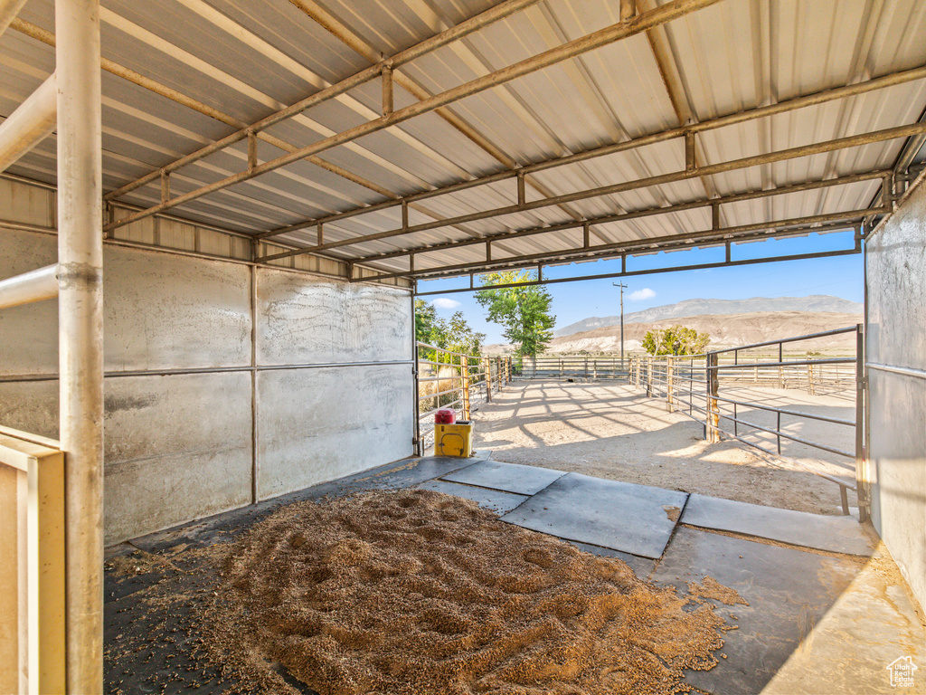 View of horse barn with a mountain view