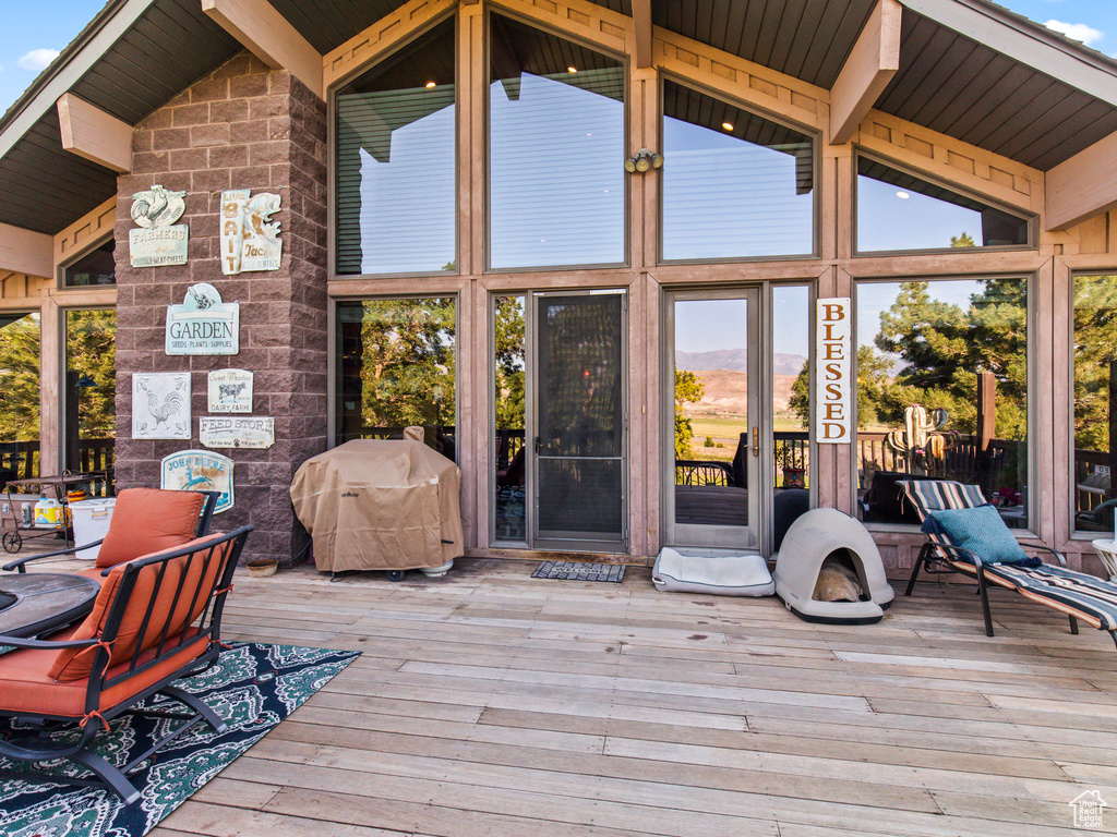 Wooden terrace featuring area for grilling