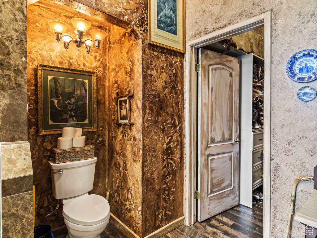 Bathroom with toilet and hardwood / wood-style floors