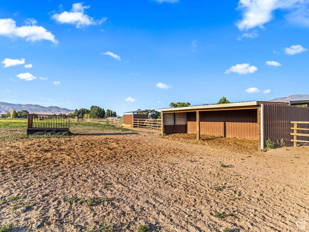 Exterior space featuring a mountain view, an outdoor structure, and a rural view