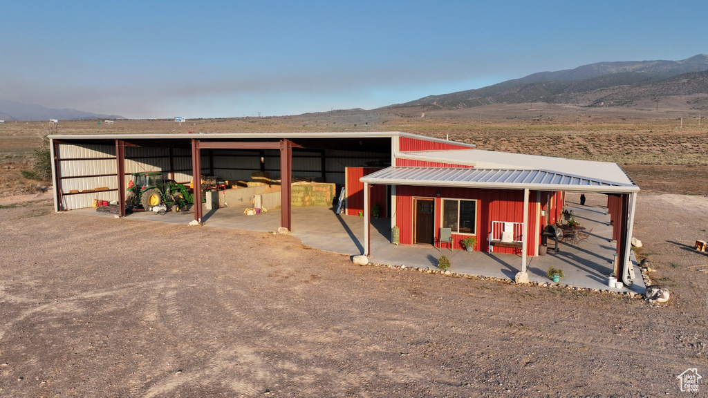 View of front facade featuring an outbuilding, a mountain view, and a rural view