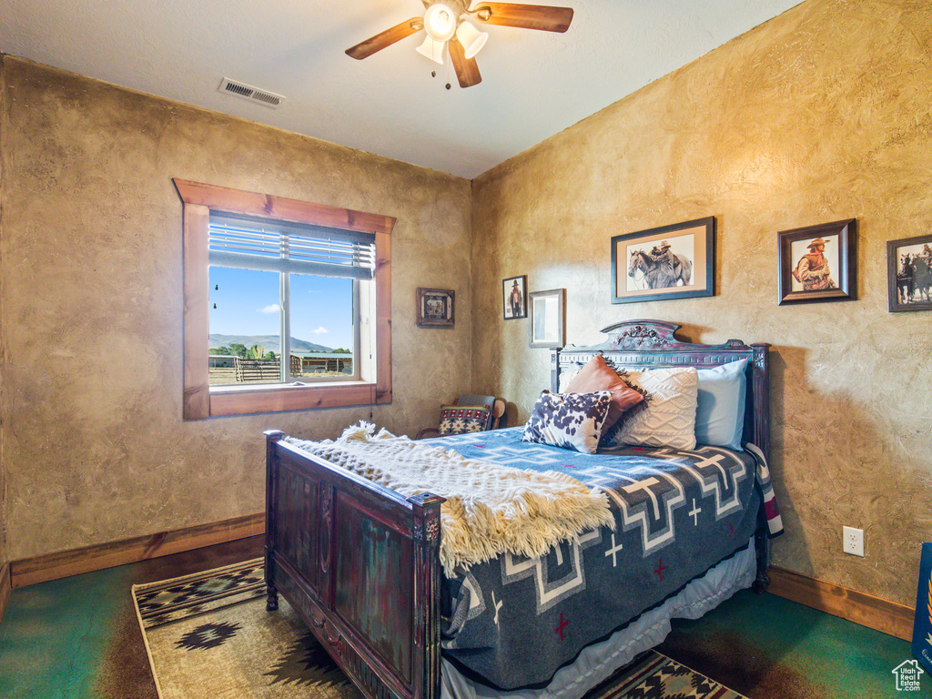 Bedroom featuring carpet and ceiling fan