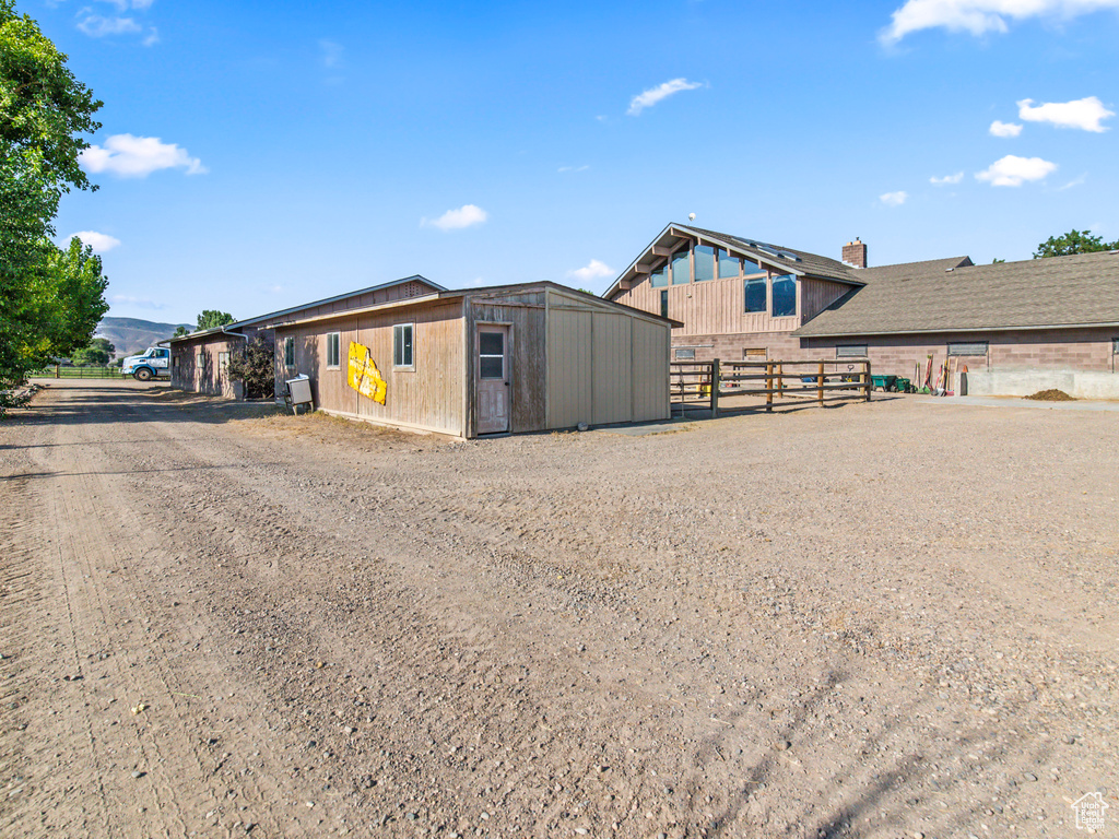 View of front of house with a storage shed