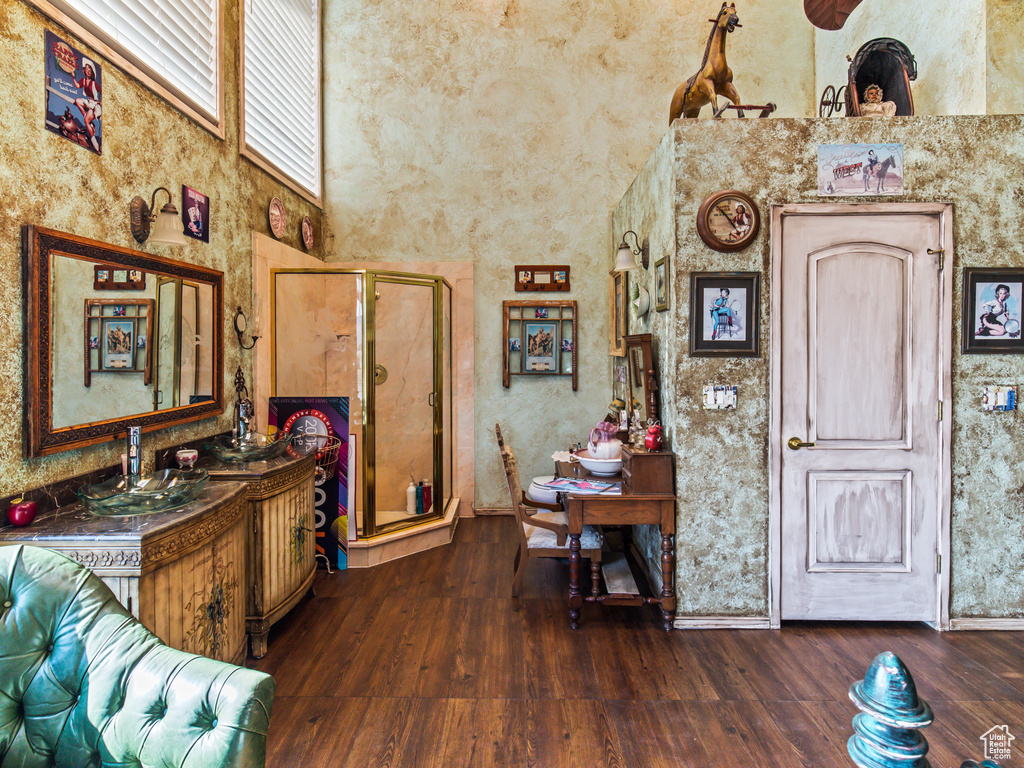 Kitchen featuring dark wood-type flooring and a towering ceiling