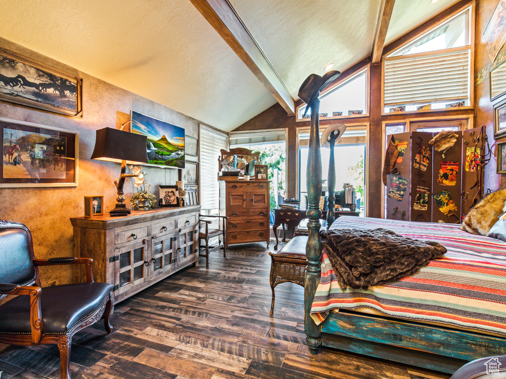 Bedroom featuring beam ceiling, hardwood / wood-style flooring, and high vaulted ceiling