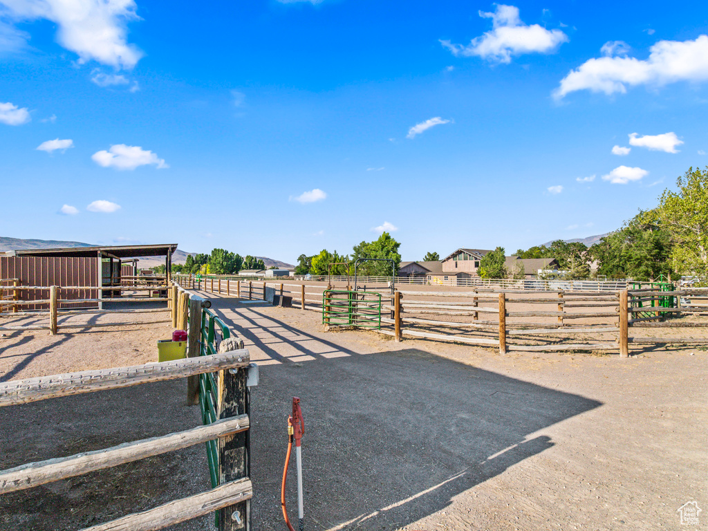 View of horse barn featuring an outbuilding