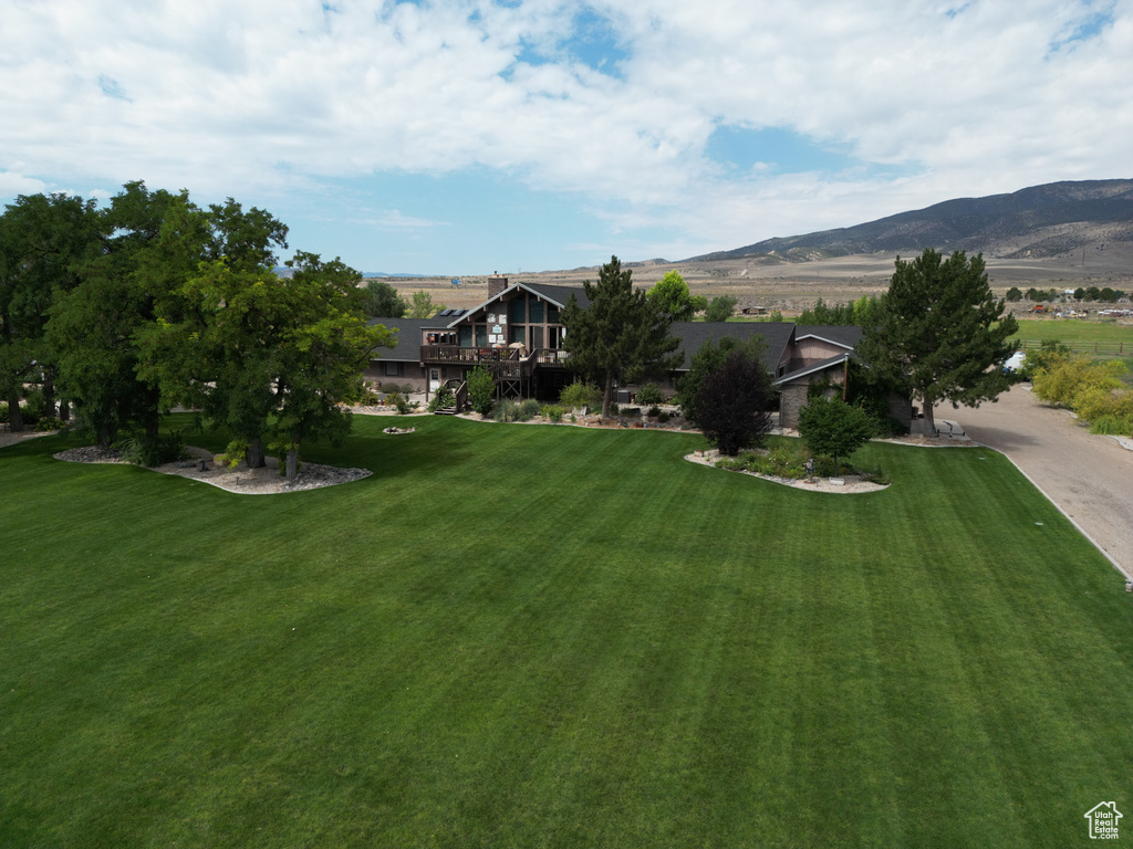 Exterior space with a mountain view and a front yard