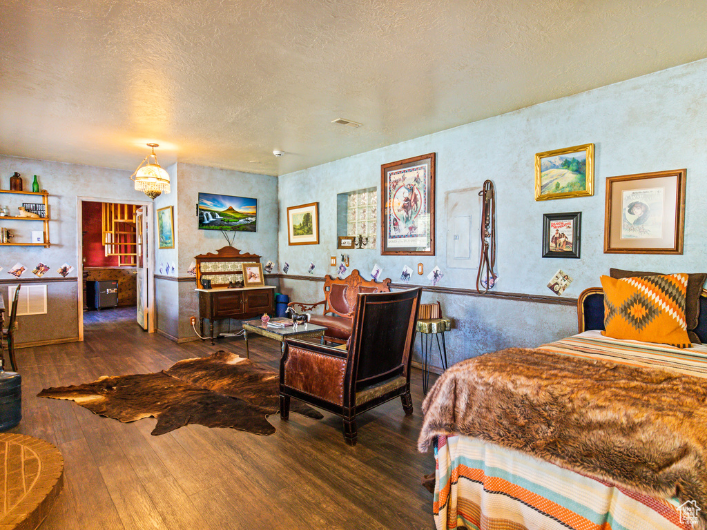 Bedroom featuring dark hardwood / wood-style floors and a textured ceiling