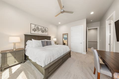 Bedroom featuring light colored carpet and ceiling fan