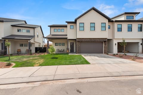 View of front of property featuring a garage and a front yard