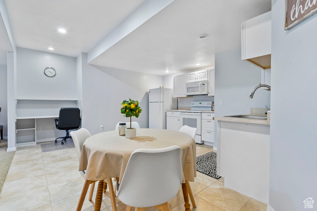 Tiled dining area featuring sink