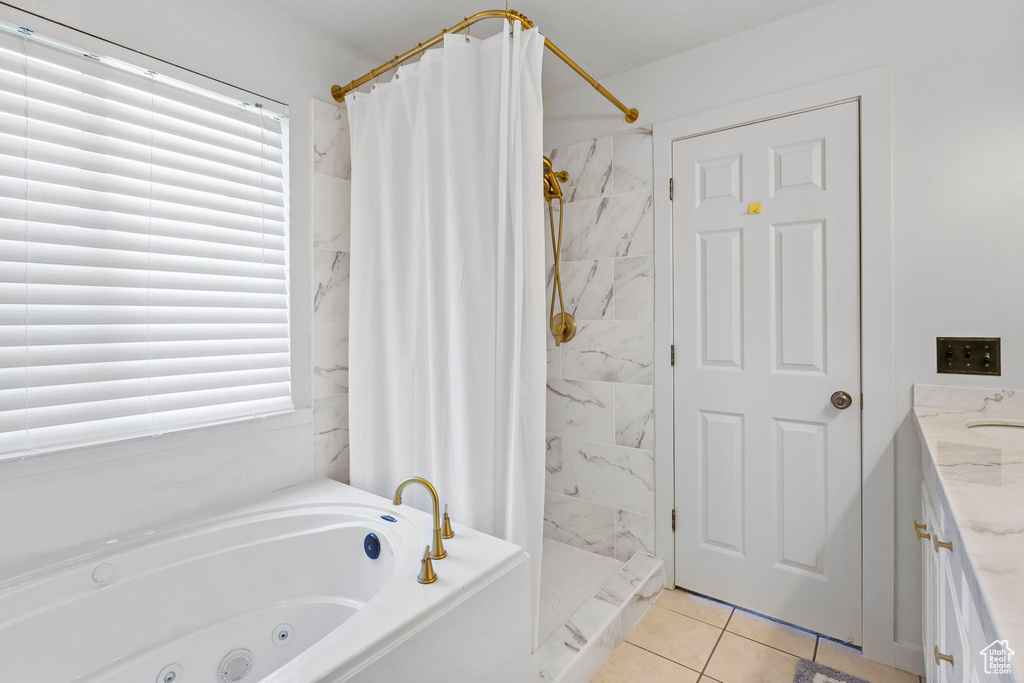 Bathroom featuring tile patterned floors and vanity