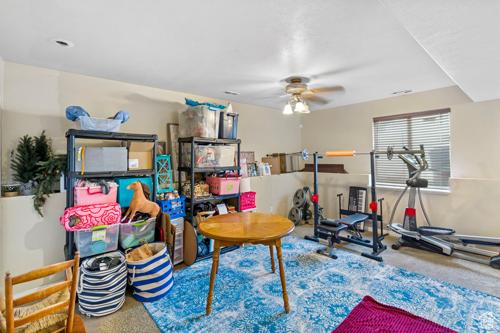 Interior space with carpet floors and ceiling fan