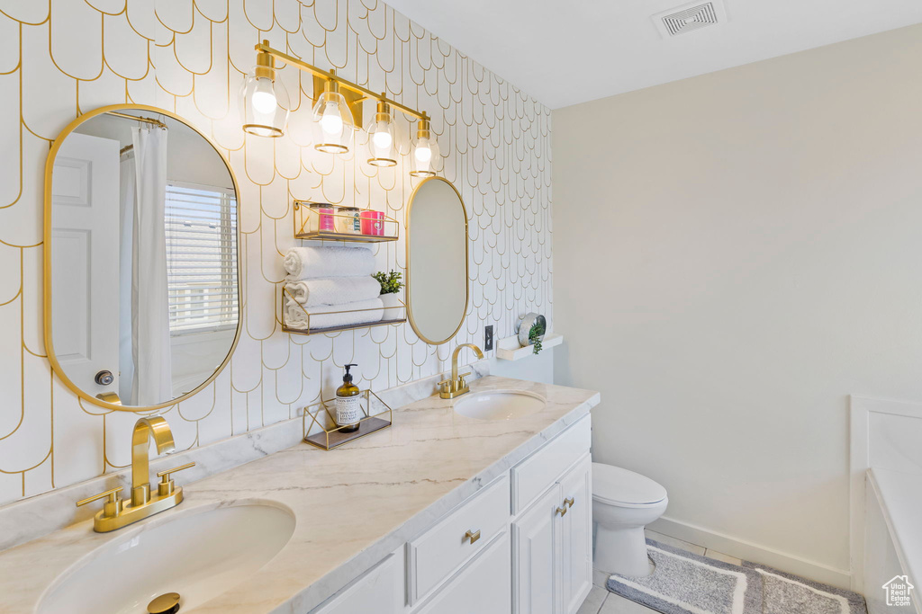 Bathroom with double vanity and toilet